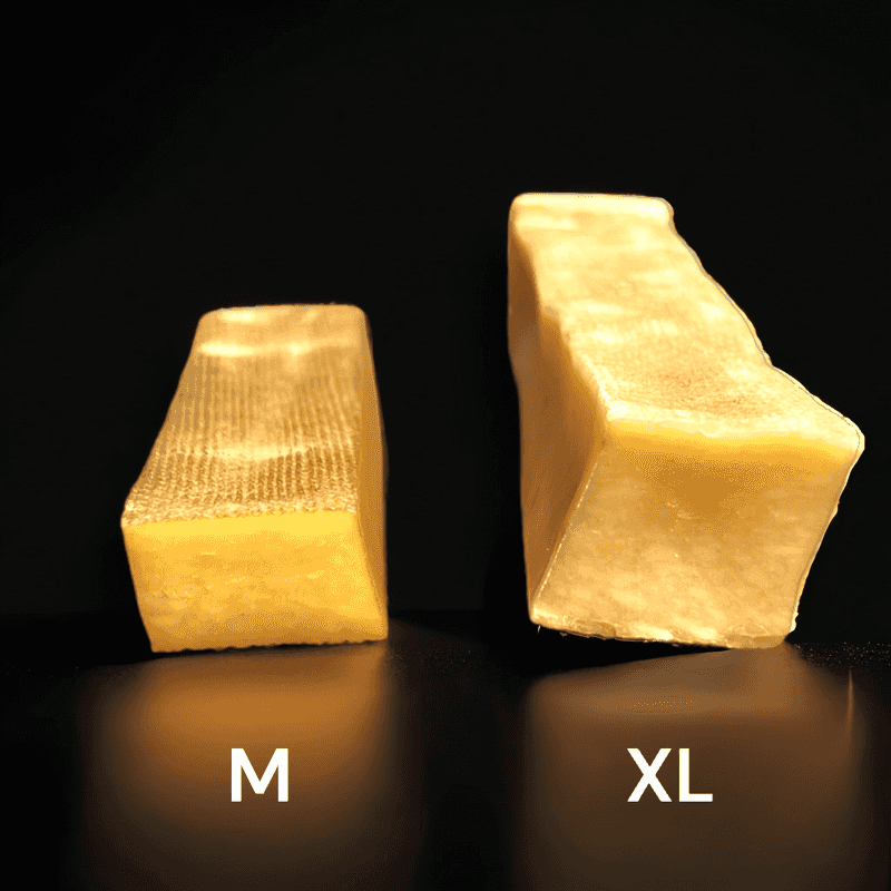 A photo of medium and xl yak chew next to each other on a black background, showing that the medium Yak chew is half of the thickness of the XL yak chew - Image 7